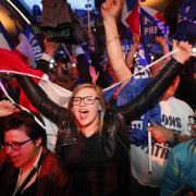 Supporters of far-right leader and candidate for the 2017 French presidential election, Marine Le Pen, celebrate after exit poll results of the first round of the presidential election are announced at election day headquarters in Henin-Beaumont,