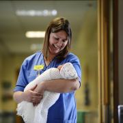 Midwife Elaine Dallas poses for a photograph with baby Sadie O'Donnell. Picture: Jamie Simpson / Herald & Times