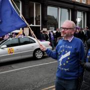SUPPORT: A couple wave a flag representing the EU member states as UKIP supporters gather outside The Cosmopolitan pub in Hartlepool. Picture: STUART BOULTON
