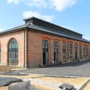 SOCIAL HOUSING: The restored Haughton Road engine shed, as seen this week, as it nears the end of its conversion. The housing on top of the roof is a clerestory - a ventilator that let the steam and smoke from the engines escape