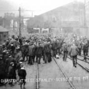 WAITING FOR NEWS: The scene at the pithead after the explosion. Below, crowds turn out for one of the funeral processions