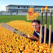 DUCK RUNNING: Durham County cricketer Gary Pratt in a sea of ducks at the Durham ground to launch the Grand Durham Duck race