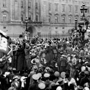 Royalty, servicemen and civilians celebrating together outside Buckingham Palace after the announcement of the Armistice which heralded the end of the First World War
