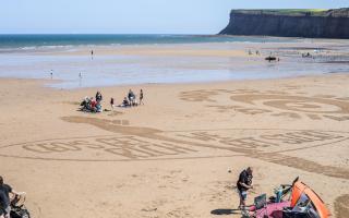 A campaign message against sewerage spills on Saltburn beach