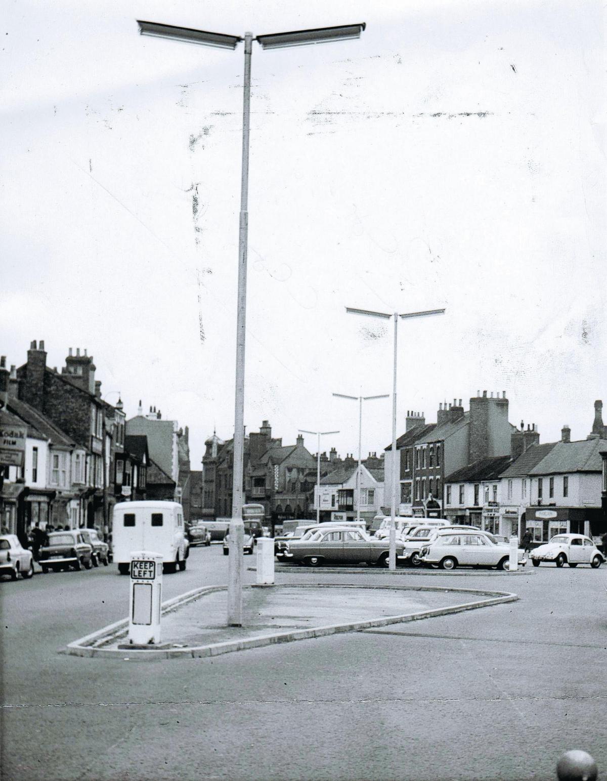 On July 25, 1962, when this picture was taken, it was possible to park in the centre of Bondgate in Darlington. Judging by the words "lamp standards" scrawled on the back of the picture, the photo was taken to illustrate the newly-installed, futuristic li