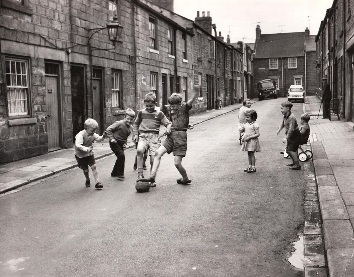 Children make their own fun in the back streets of Bishop Auckland in 1960.