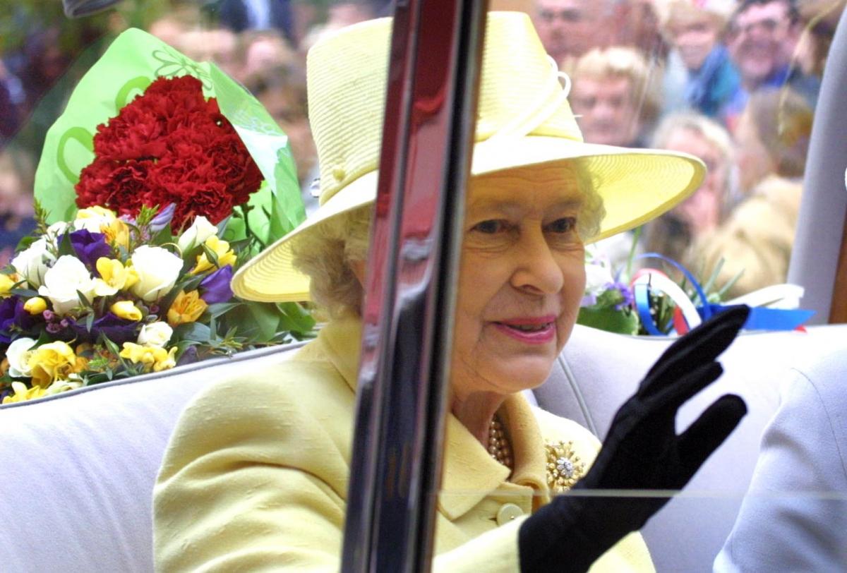 The Queen waves to the crowds from the Royal car as she passes through Darlington on her jubilee tour of the region