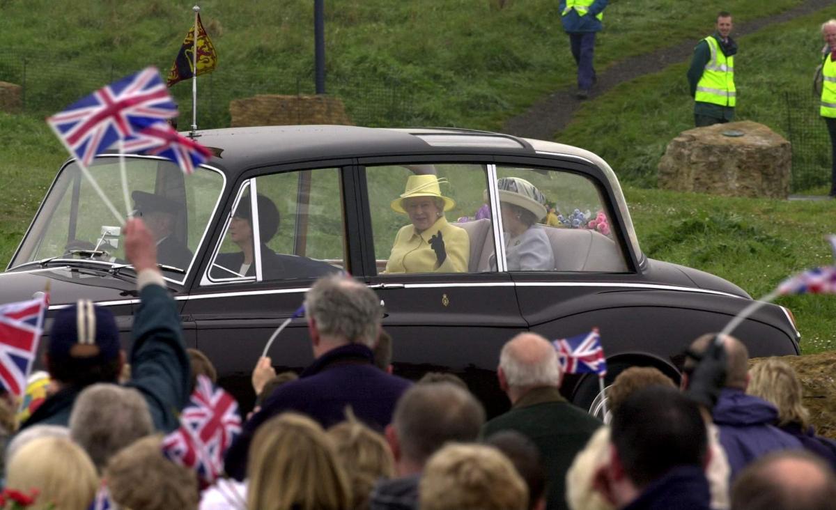 The Queen smiling as she arrives to meet the people who gathered at Blackhall Rocks, in County Durham, when she arrived to unveil a Cairn, as part of her Golden jubilee tour of the nation