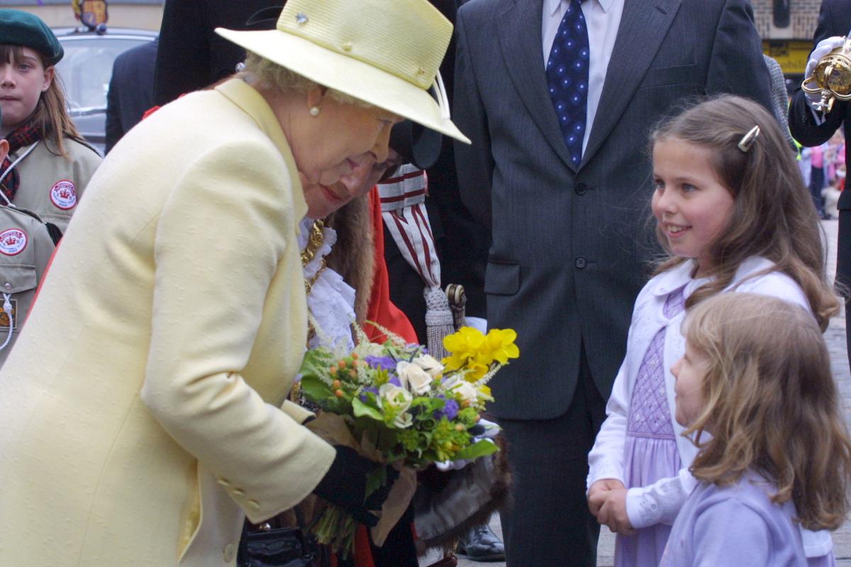 The Queen is presented with flowers by sisters Rebecca and Harriet Ashley during the Queen's Jubilee visit to Darlington