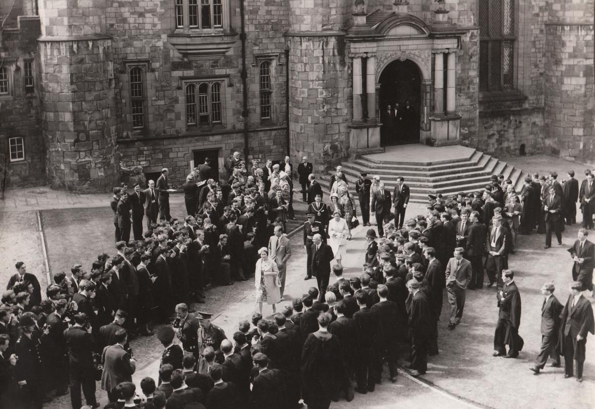 Durham University students line the path as the Queen walks through the grounds of Durham Castle during her visit in May 1960