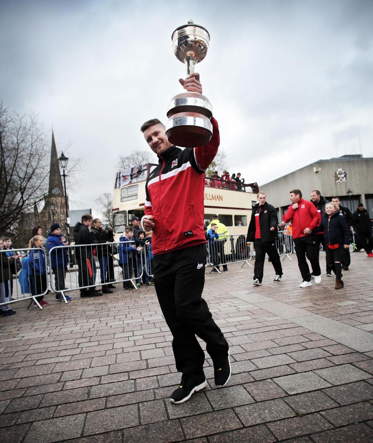 Darlington FC's open top bus victory home coming. Kev Burgess with the trophy. Picture by Stuart Boulton.