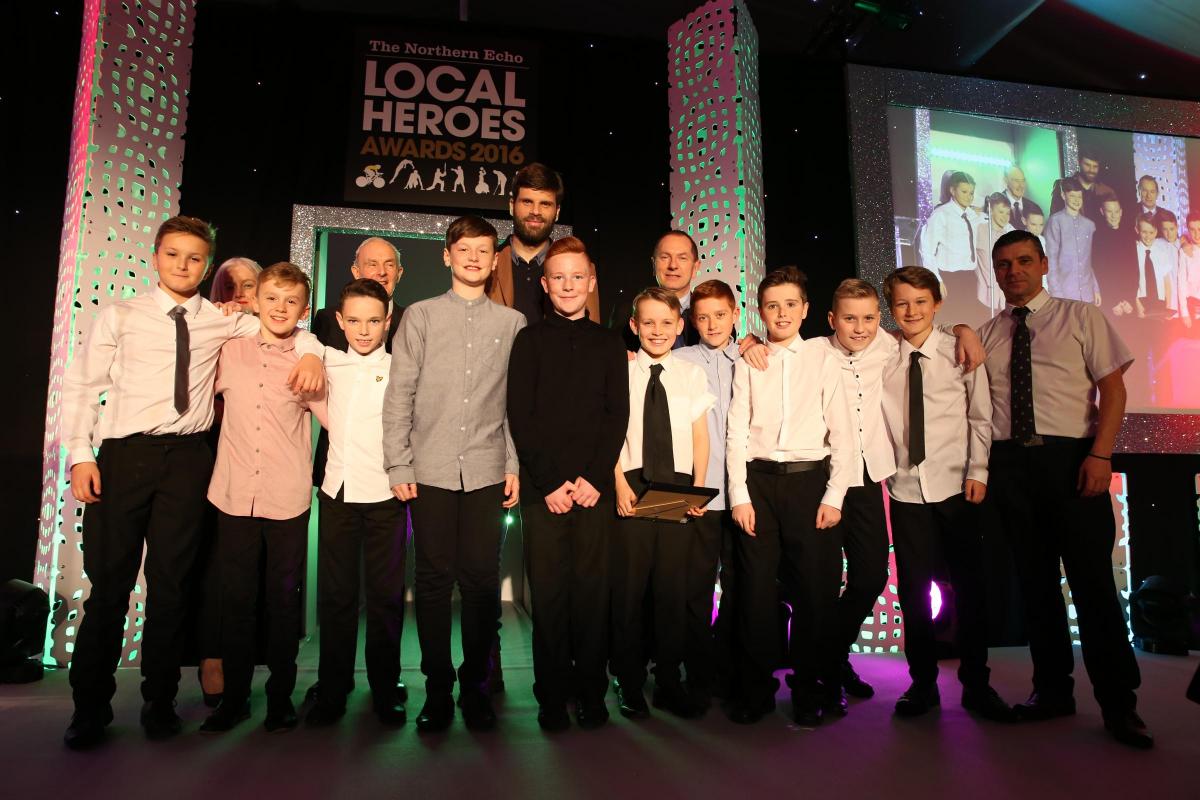 Sarah Armstrong from Story Homes and a very safe pair hands – Boro goalkeeper and one of the promotion year heroes, Dimi Konstantopolous - present the Junior Team/Club of the Year Award to Darlington District Under-11s Primary Schools Footballl Team