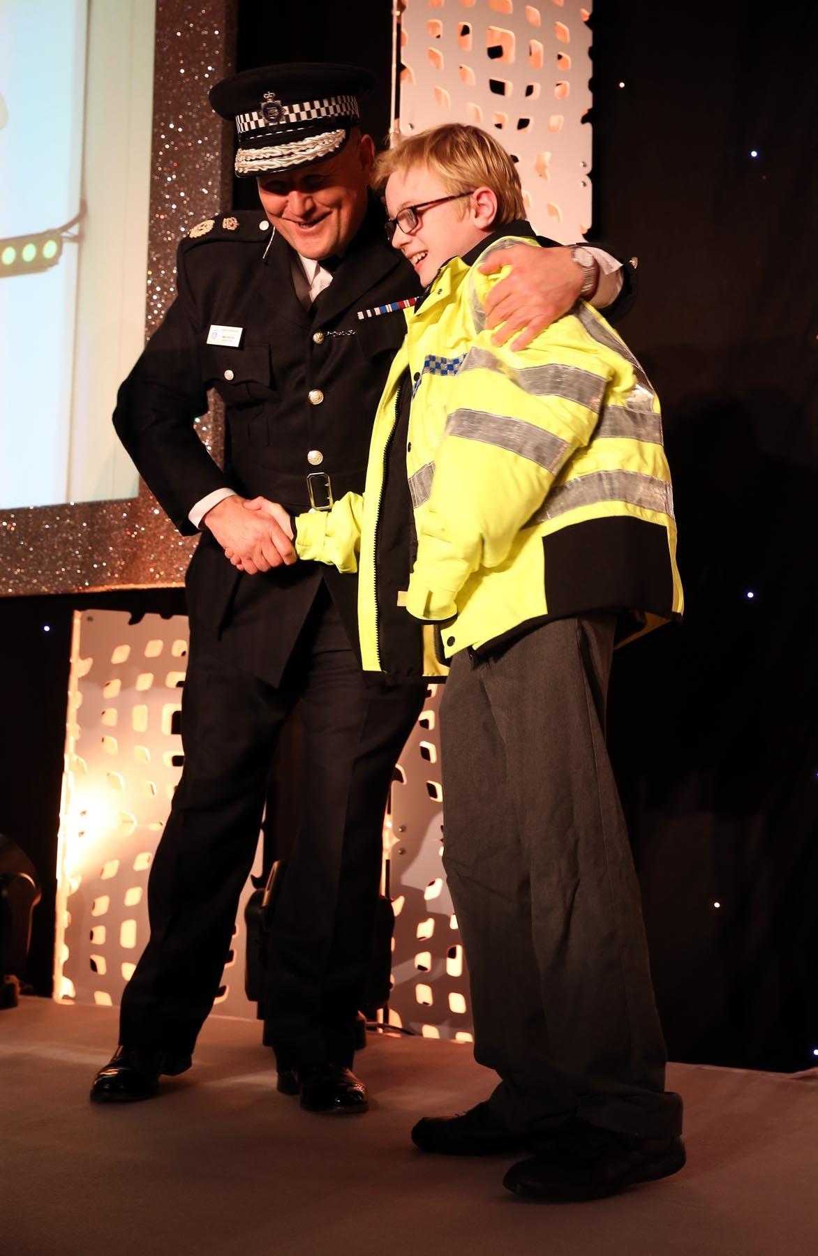 Chief Constable of Durham Constabulary, Mike Barton, presents Charlie with a mini police jacket after the 11-year-old expressed dreams of becoming a police officer. Picture: CHRIS BOOTH
