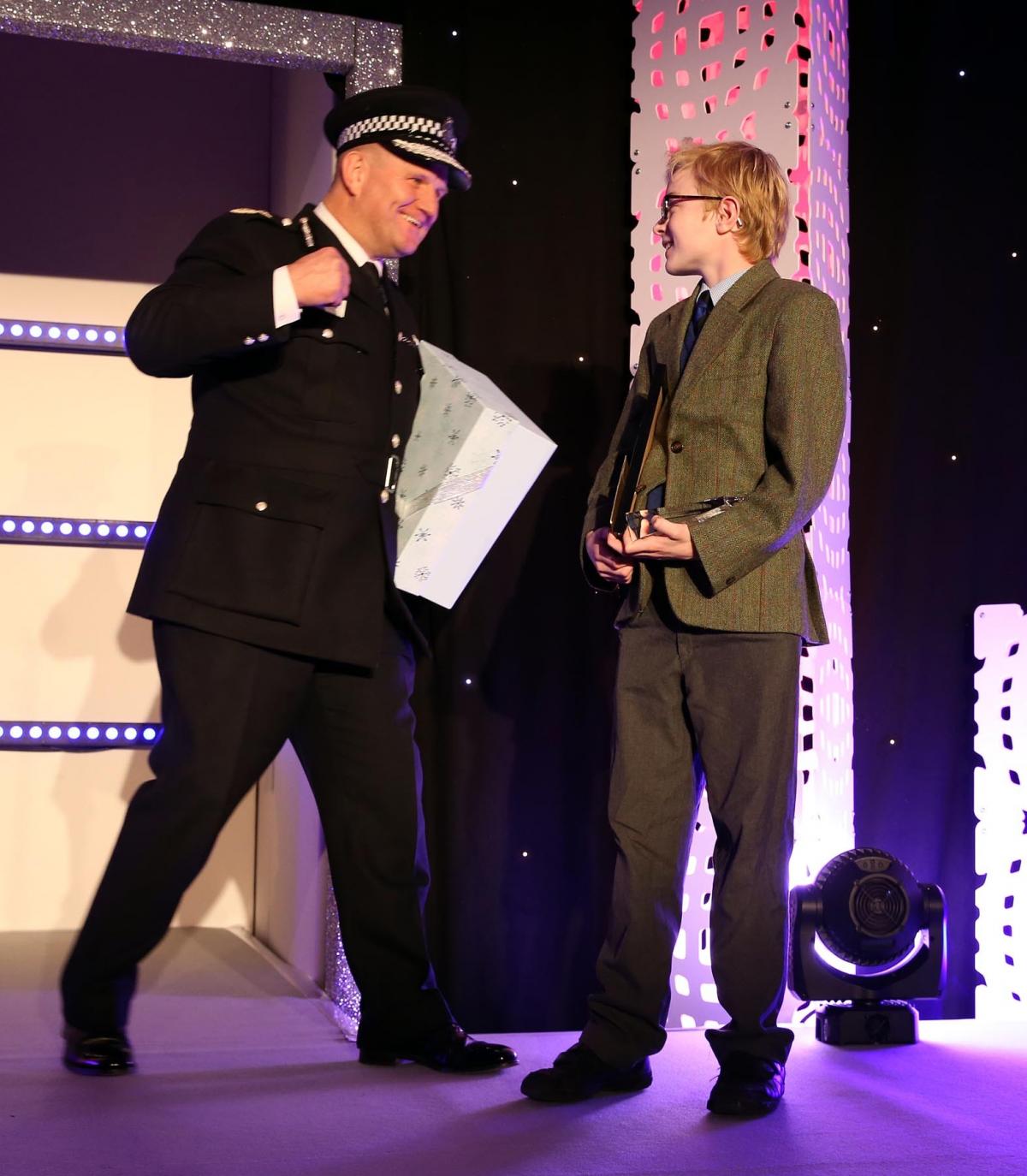 Chief Constable of Durham Constabulary, Mike Barton, presents Charlie with a signed copy of the Police Interceptors 2017 calendar after the 11-year-old expressed dreams of becoming a police officer. Picture: CHRIS BOOTH