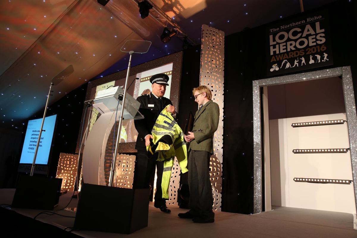 Chief Constable of Durham Constabulary, Mike Barton, presents Charlie with a mini police jacket after the 11-year-old expressed dreams of becoming a police officer. Picture: CHRIS BOOTH