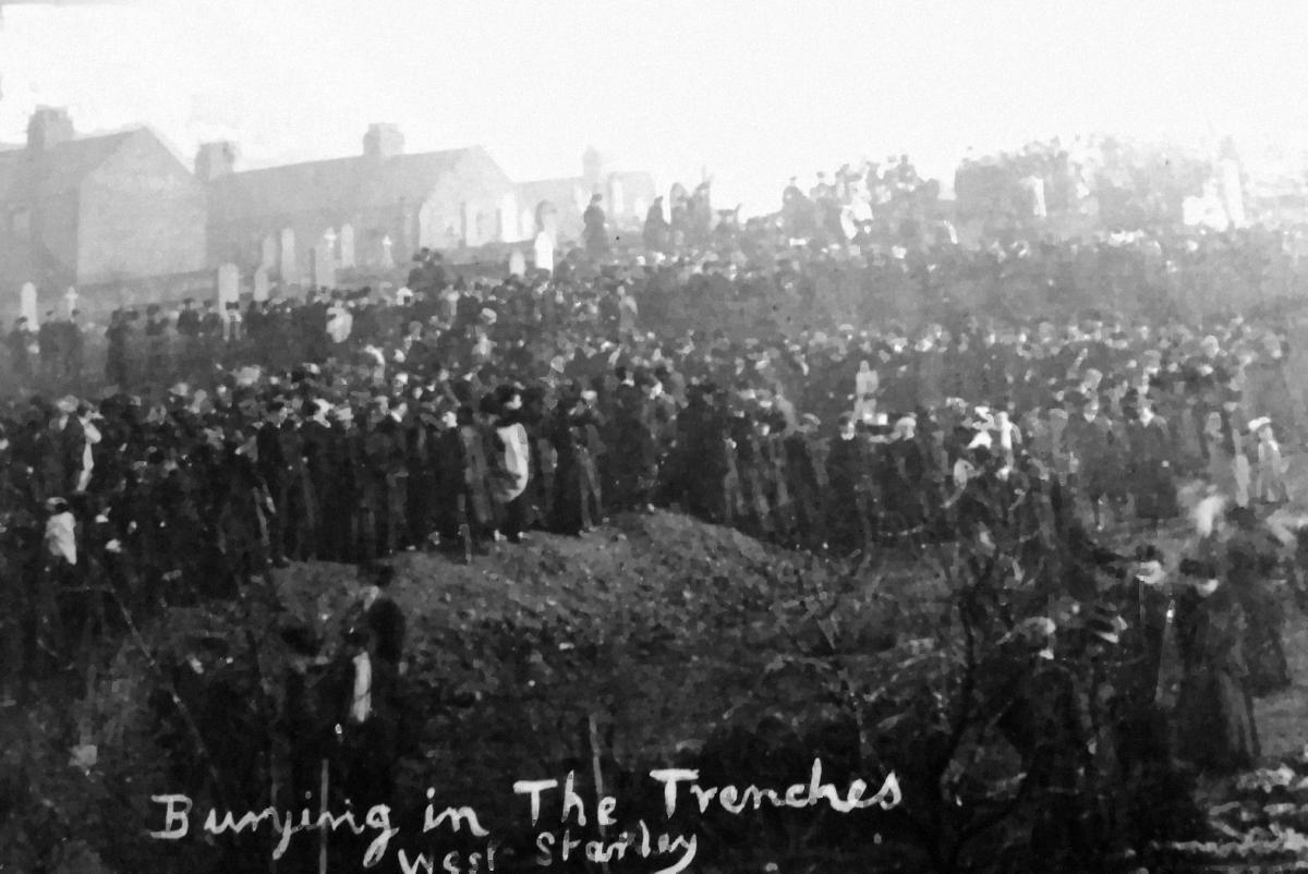 Crowds gather in West Stanley to bury the dead in mass graves.