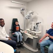 Specsavers optometrist Williams Okezie, Frankie Crow and Liam Crow