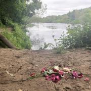 Floral tributes on the banks of the River Tyne.