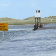 Holy Island Causeway and Refuge Box, with fast flowing tide.