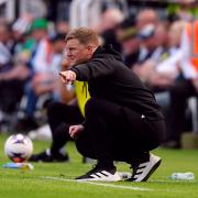 Eddie Howe crouches on the touchline during Newcastle's weekend draw with Brighton