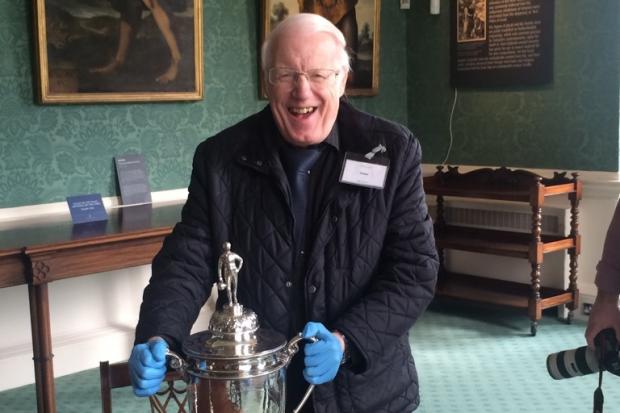 FOOTBALL: Chairman of the Durham Amateur Football Trust, Keith Belton with the Amateur Cup won many times by his beloved Bishop Auckland. He is holding the cup in Auckland Castle, Bishop Auckland