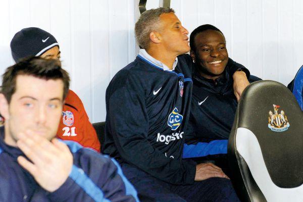 TOP TARGET: Victor Moses, pictured being hugged by Palace coach Keith Curle on the bench at St James’ Park on Wednesday, is still wanted by Chris Hughton