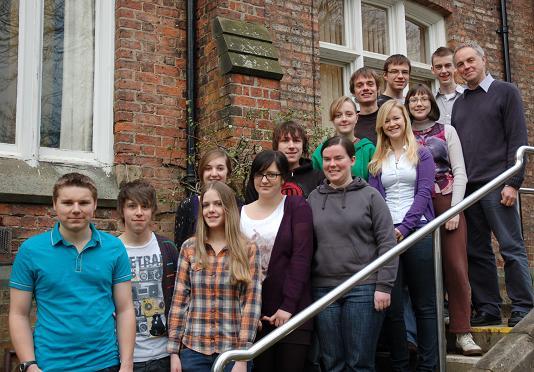 Queen Elizabeth College's Oxbridge co-ordinator Simon Nicholson with 13 of his successful students