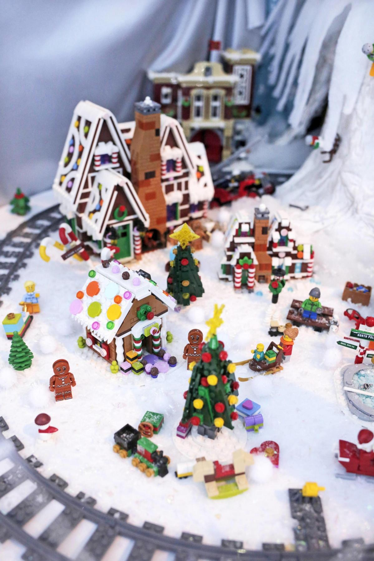 Family light up Frosterley shop window with Lego display