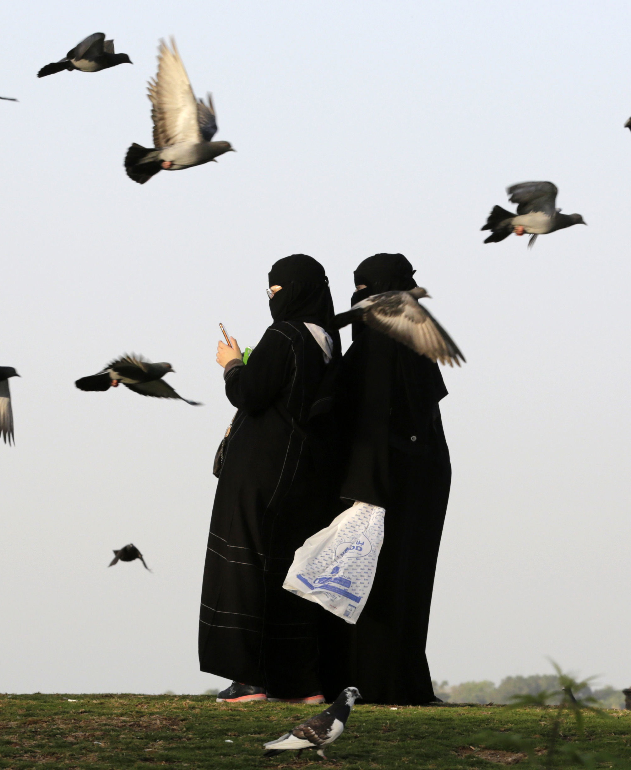 Saudi women film pigeons at a public garden in Jiddah, Saudi Arabia, ahead of International Women’s Day Picture: AMR NABIL/AP