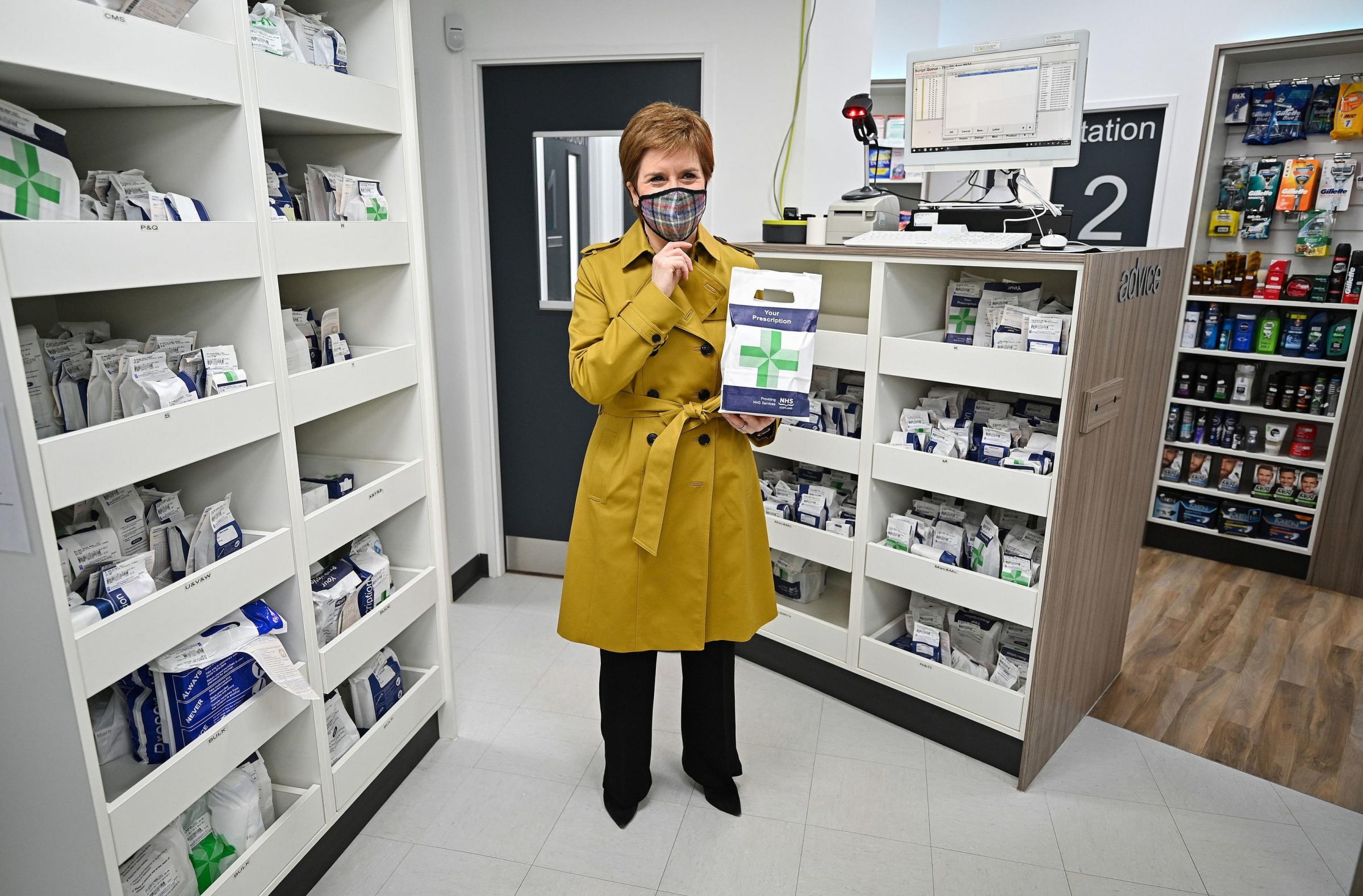 First Minister and leader of the Scottish National Party Nicola Sturgeon at a Burnside chemist in Rutherglen during campaigning for the Scottish Parliamentary election Picture: JEFF J MITCHELL/PA