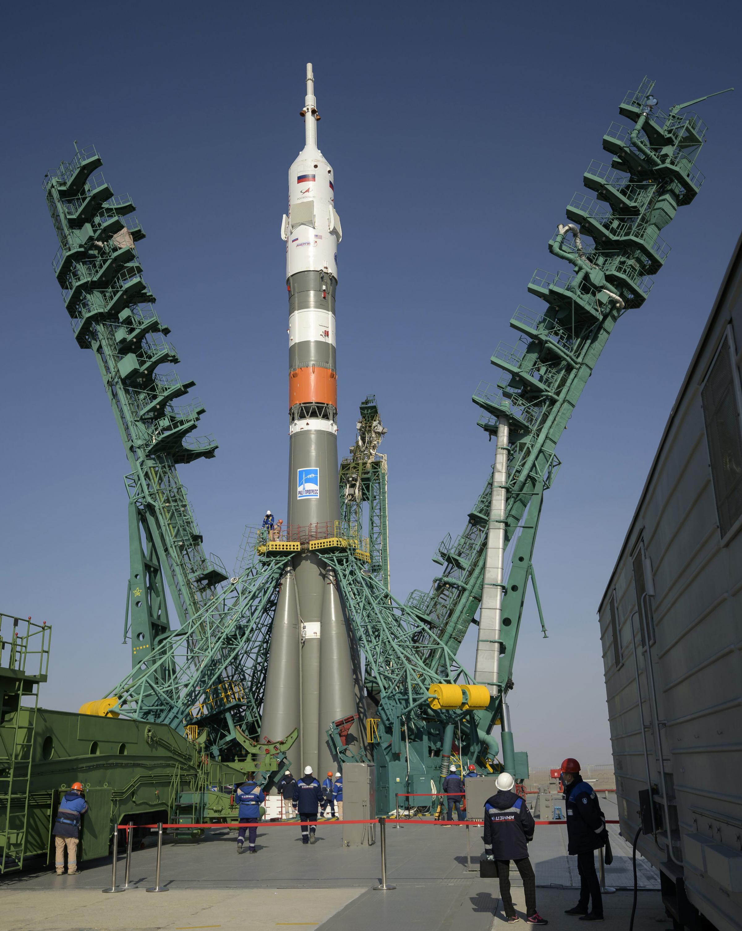 The service structure is lifted into position around a Soyuz rocket, at site 31 of the Baikonur Cosmodrome in Kazakhstan. Expedition 65 NASA astronaut Mark Vande Hei, Roscosmos cosmonauts Pyotr Dubrov and Oleg Novitskiy are scheduled to launch aboard