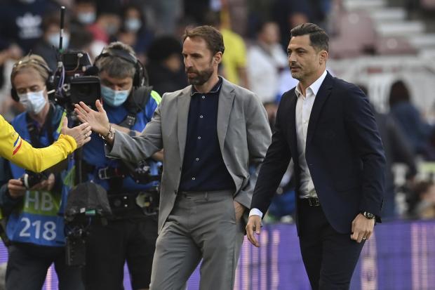 Gareth Southgate walks off with Romania boss Mirel Radoi yesterday after England warmed up for the Euros with a 1-0 win at the Riverside Stadium Picture: PAUL ELLIS/AP POOL