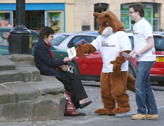 SERIOUS MESSAGE: Joshua Kaile and Fergus the Dancing Fox, from the League Against Cruel Sports, handing out leaflets in Richmond