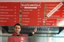 Mouhyedin Alkhalil behind the counter of Falafel Fella