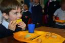 Every child in an English infant school will be eligible for a free school meal under a £600 million plan announced by Nick Clegg. Children eating their lunch at Lakes primary school, West Dyke Road, Redcar. Alfie Revell eating Melon.