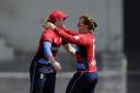 England's Danielle Hazell, right, celebrates with Bryony Smith after the wicket of Australia's Ellyse Perry during their Women's T20 Triangular Series game in Mumbai, India