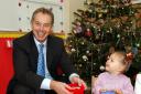 Tony Blair plays with Tia Hayton Smith, two, at the Easterside Sure Start scheme