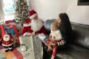 Gabriela and 18-months-old Bora meet Father Christmas at Rainham House. Picture: Peter Barron