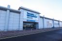 A woman tragically collapsed and died at Teesside Airport while checking in for her flight,