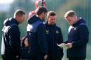 Eddie Howe discusses tactics with his fellow Newcastle United coaches at Darsley Park