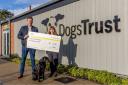 Michael Luke from Tees Valley International Film Festival hands £1,000 to Bethany Scrafton at Darlington’s Dogs Trust Credit: SARAH CALDECOTT