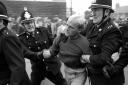Two policemen arrest a striking miner in Easington