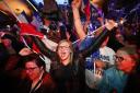 Supporters of far-right leader and candidate for the 2017 French presidential election, Marine Le Pen, celebrate after exit poll results of the first round of the presidential election are announced at election day headquarters in Henin-Beaumont,
