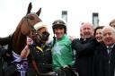PICK OF THE WEEK: Jockey Davy Russell and Owner Phillip Reynolds celebrate winning the RSA Insurance Novices' Chase on Presenting Percy
