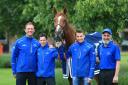 Trainer Charlie Appleby (left), day to day jockey Brett Doyle (centre left), winning jockey William Buick (centre right) and groom Saeed pose with Masar during the homecoming event at Moulton Paddocks, Newmarket after last weekend's Derby