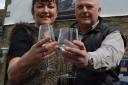 BACK IN BUSINESS: Julie and Terry Race raise a glass to toast the reopening of the George and Dragon, at Boldron.