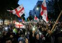 Demonstrators with Georgia flags at a protest against the bill (AP Photo/Zurab Tsertsvadze)