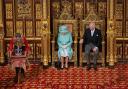 The Queen and Prince Charles sit in the chamber, alongside them is The Imperial State Crown, ahead of the State Opening of Parliament