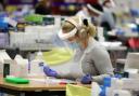 An essential worker at a Covid testing centre. Credit: PA