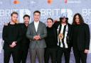 Sam Fender (centre-left) attending the Brit Awards 2022 at the O2 Arena, Londo (PA)